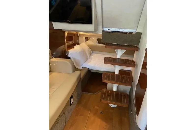 Yacht Photos Pics Interior of 2012 Sea Ray 350 Sundancer with wooden steps and cozy seating area.