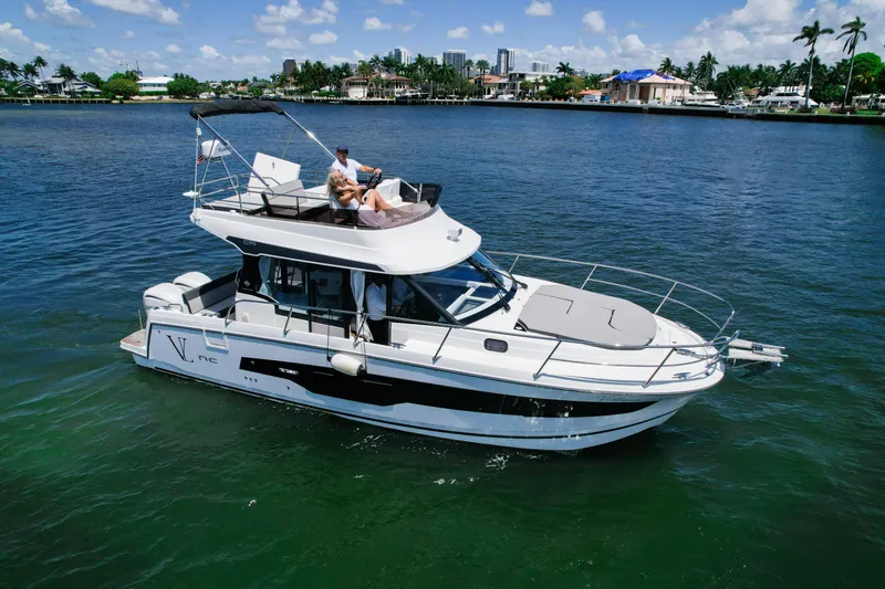  Yacht Photos Pics 2024 Jeanneau NC1095 Fly yacht cruising on a sunny day with passengers relaxing.