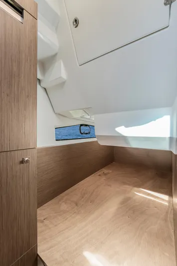  Yacht Photos Pics 2024 Jeanneau NC1095 Fly cabin interior with wood finish and window view.