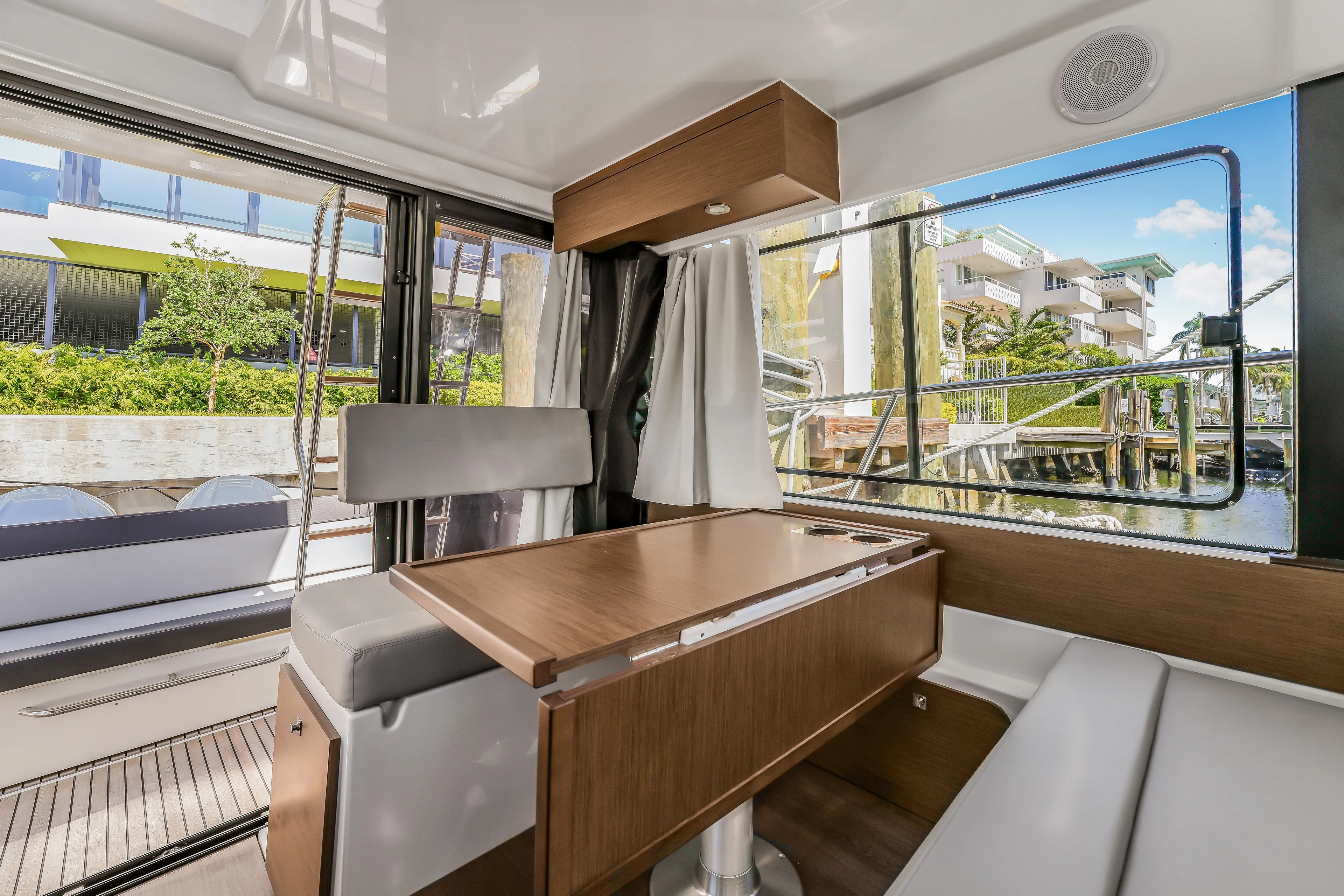  Yacht Photos Pics Interior of 2024 Jeanneau NC1095 Fly yacht with modern seating and large windows.