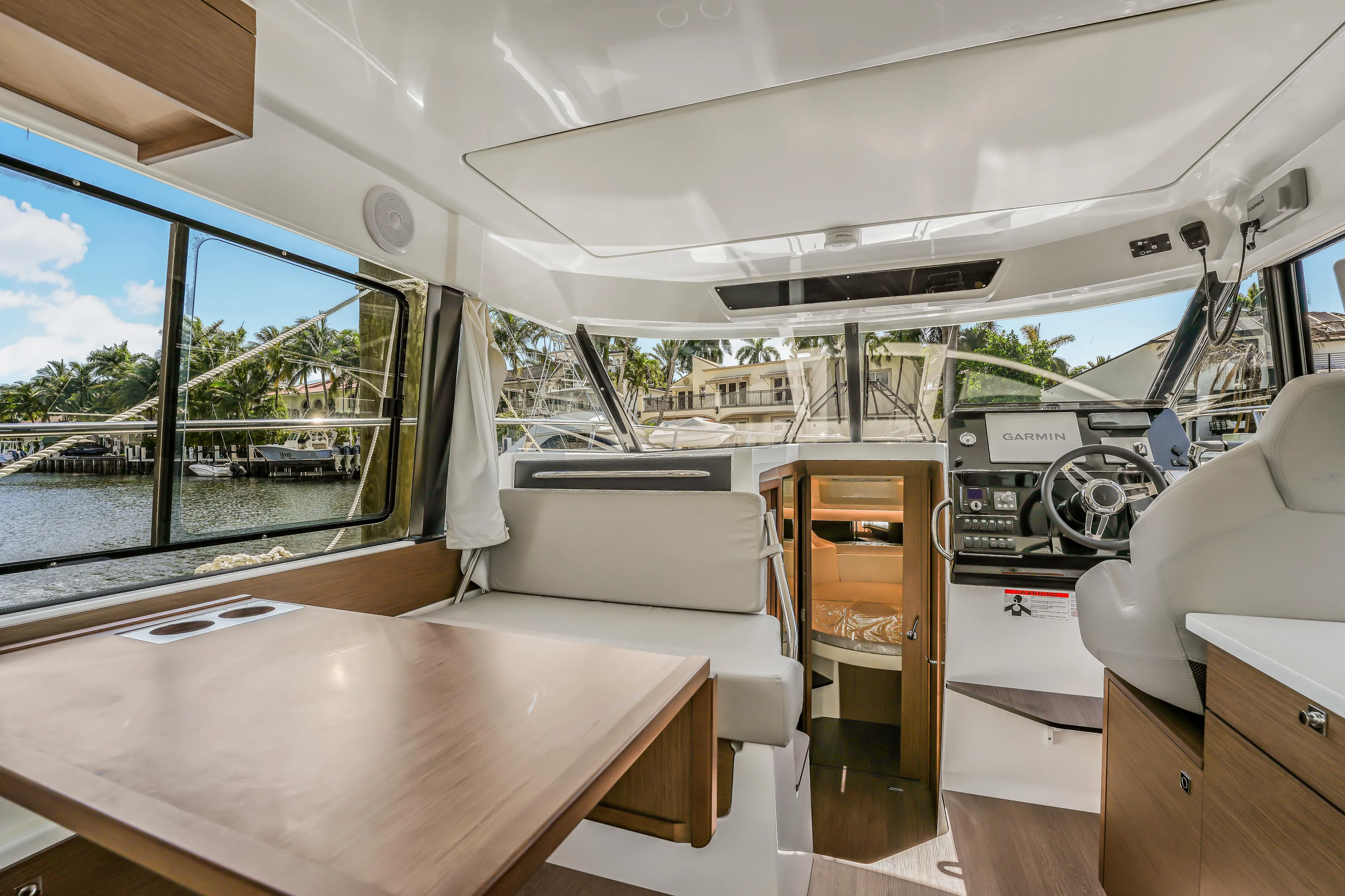  Yacht Photos Pics Interior of 2024 Jeanneau NC1095 Fly yacht, featuring modern helm and seating area.