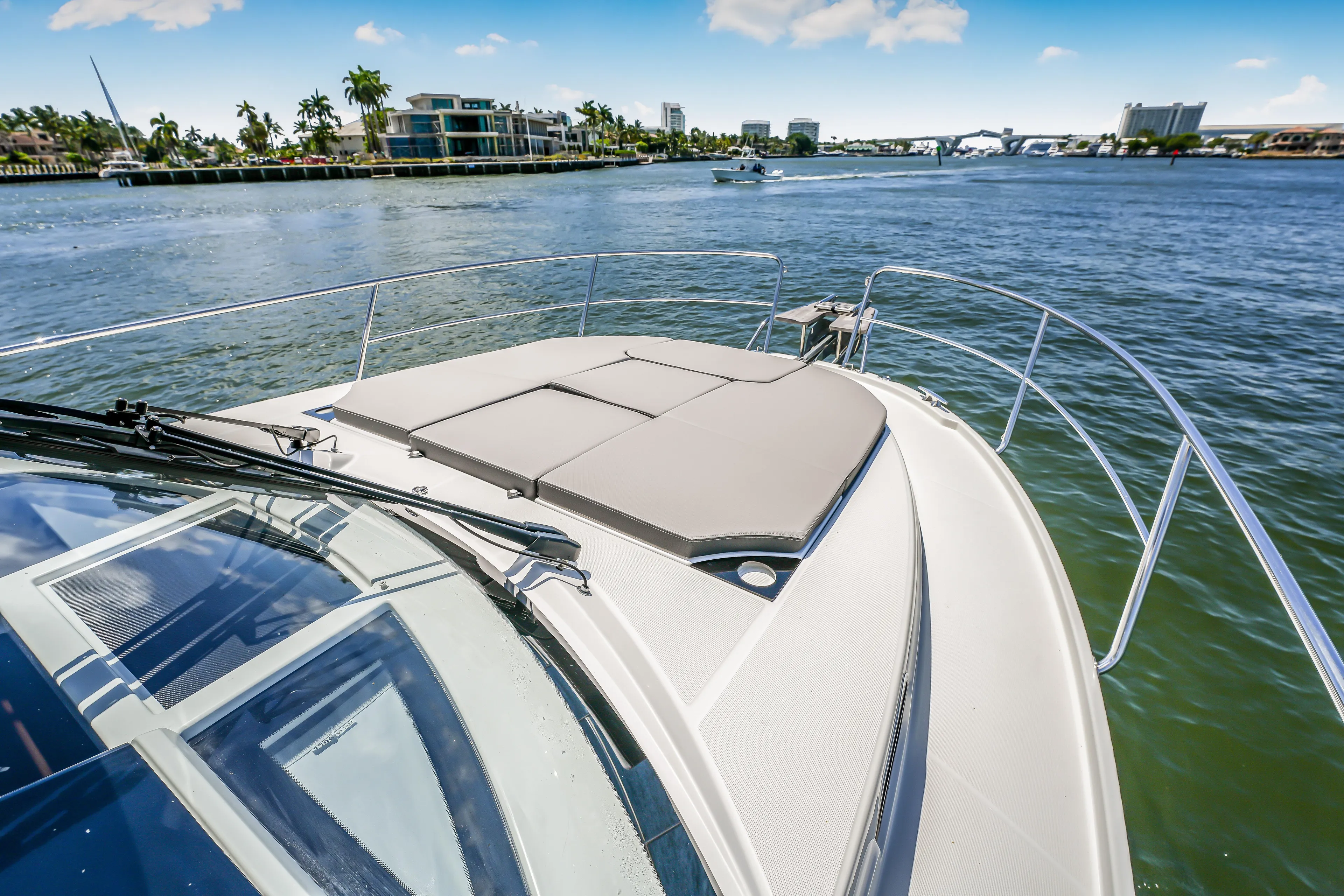  Yacht Photos Pics 2024 Jeanneau NC1095 Fly yacht cruising on a sunny day, featuring a spacious deck.