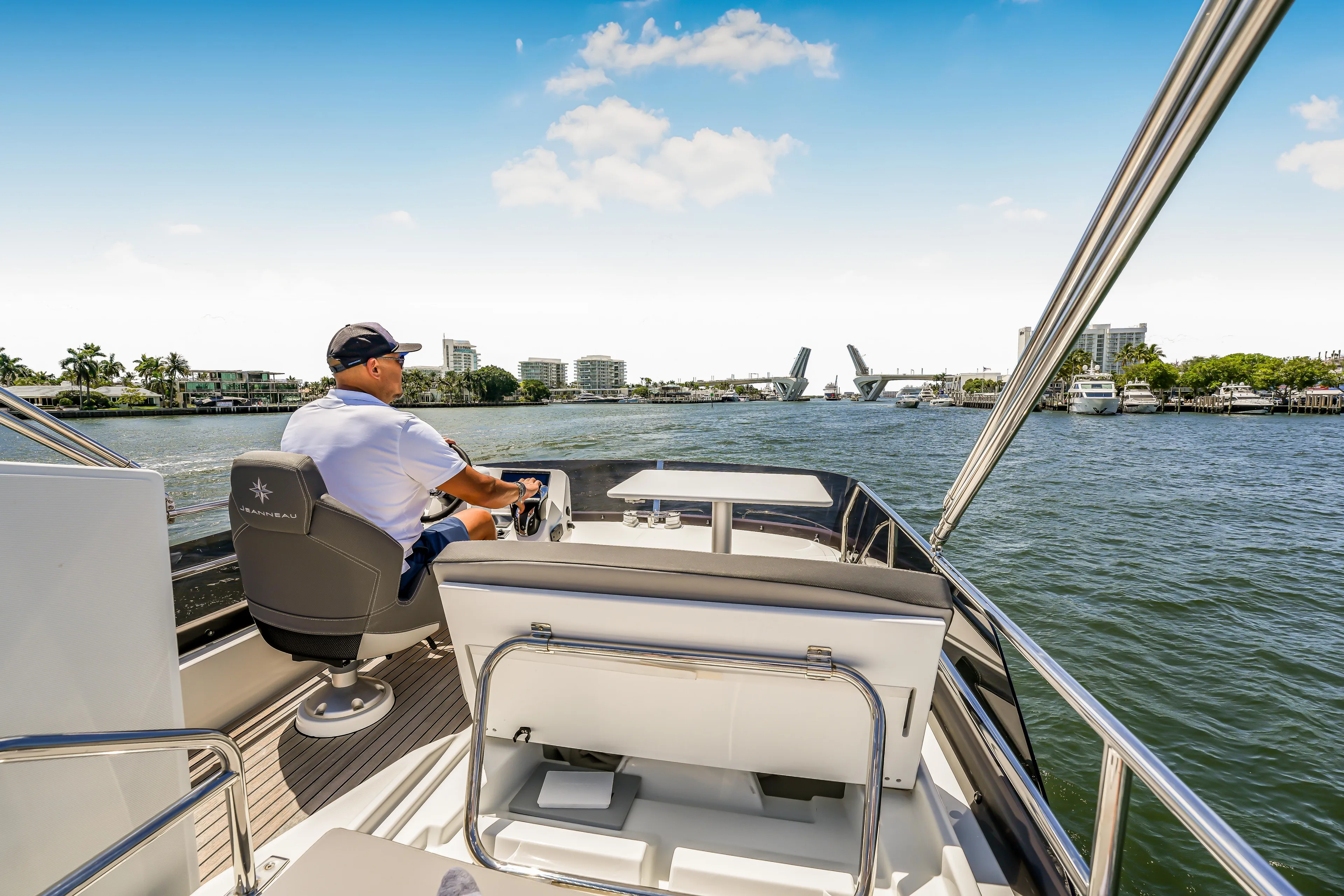  Yacht Photos Pics 2024 Jeanneau NC1095 Fly cruising on a sunny day with a scenic waterfront view.