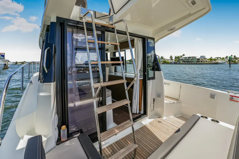  Yacht Photos Pics 2024 Jeanneau NC1095 Fly yacht with flybridge, docked on a sunny day.