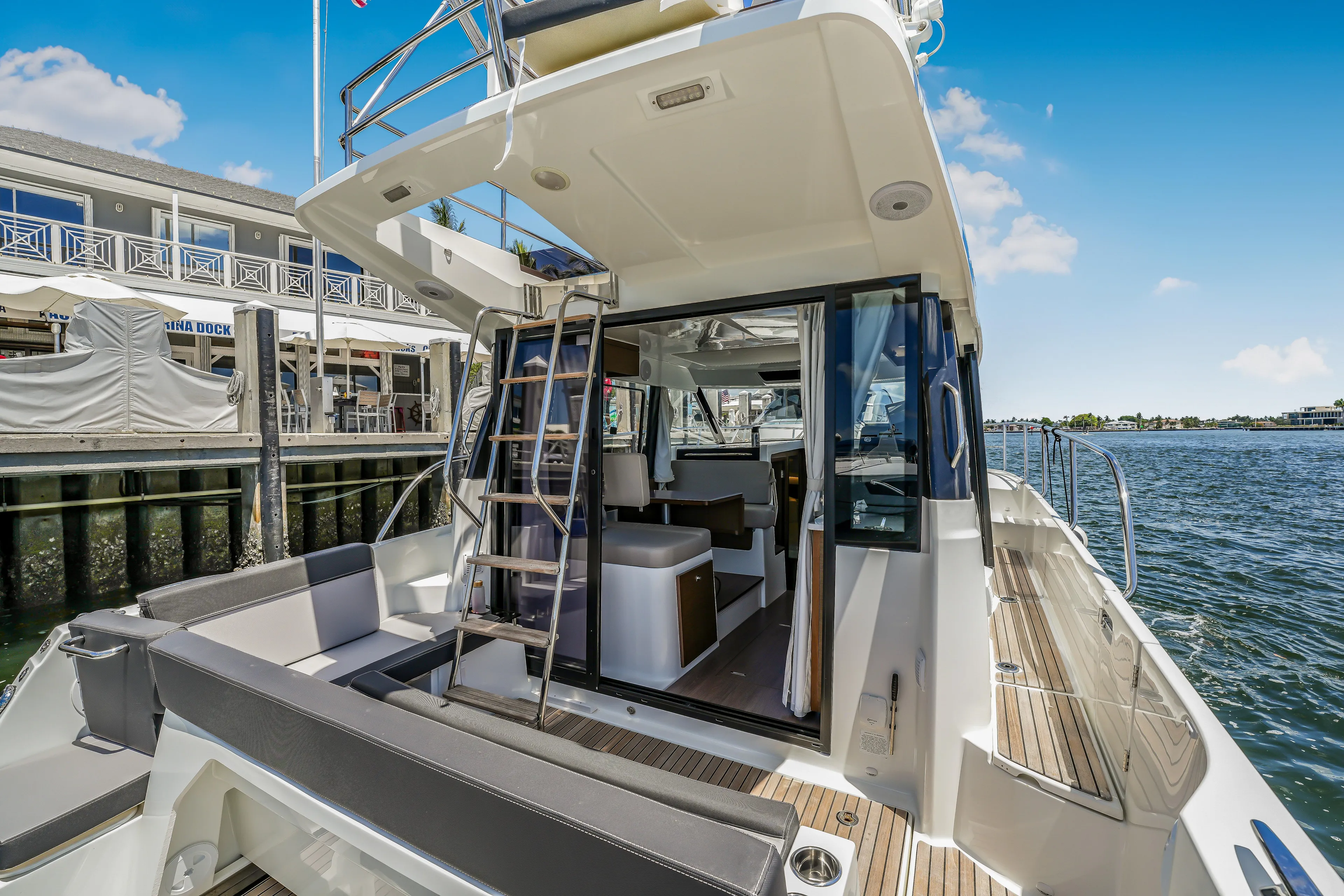  Yacht Photos Pics 2024 Jeanneau NC1095 Fly yacht with open deck and marina view.