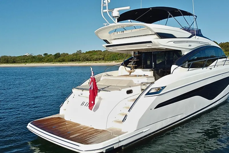 B III Yacht Photos Pics Luxurious 2021 Princess S62 yacht on serene water, featuring sleek design and spacious deck.