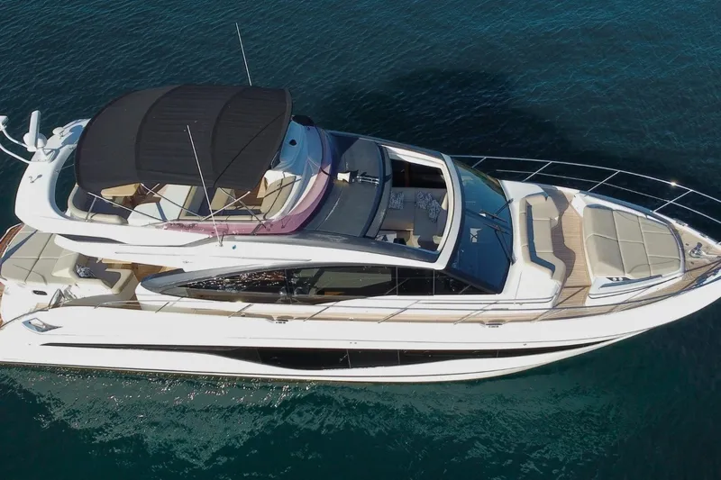 B III Yacht Photos Pics 2021 Princess S62 yacht on clear blue water, aerial view.