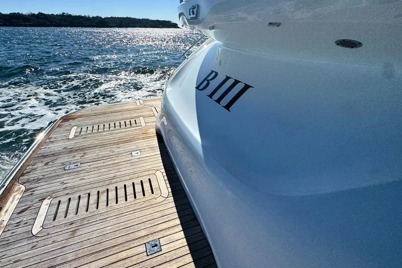 B III Yacht Photos Pics 2021 Princess S62 yacht on water, featuring wooden deck and sleek design.