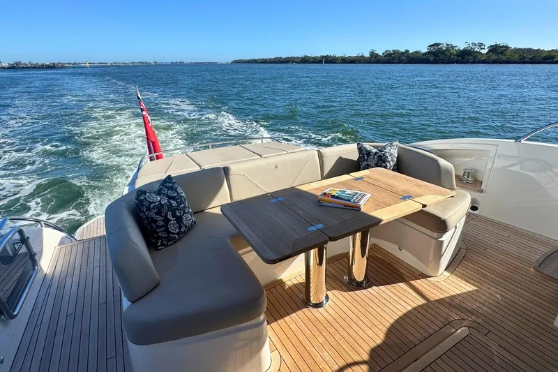 B III Yacht Photos Pics Luxurious 2021 Princess S62 yacht deck with seating, table, and scenic water view.