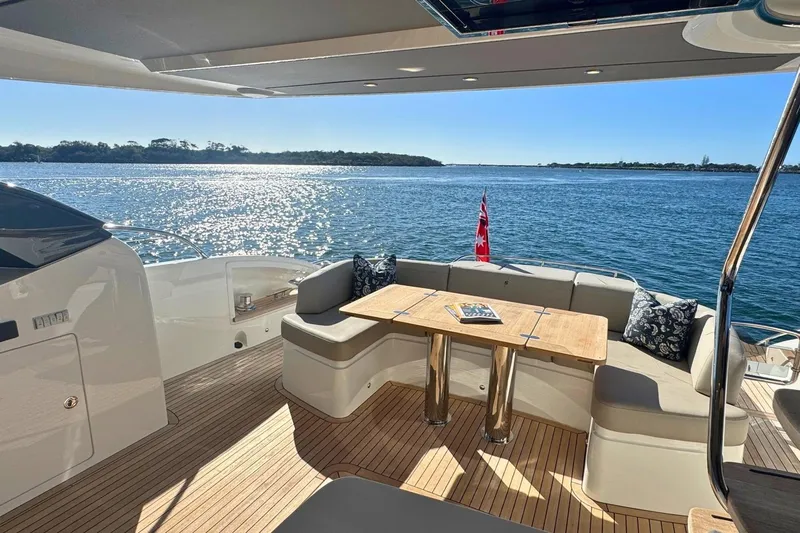 B III Yacht Photos Pics Luxurious 2021 Princess S62 yacht deck with seating, table, and ocean view.