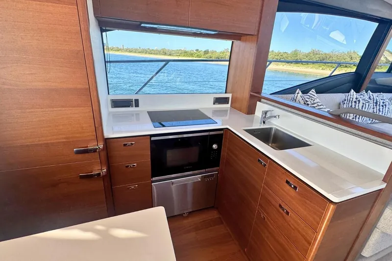 B III Yacht Photos Pics Luxurious 2021 Princess S62 yacht kitchen with modern appliances and scenic water view.
