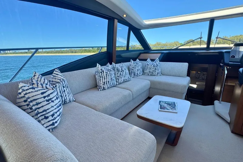 B III Yacht Photos Pics Luxurious interior of 2021 Princess S62 yacht with elegant seating and scenic ocean view.