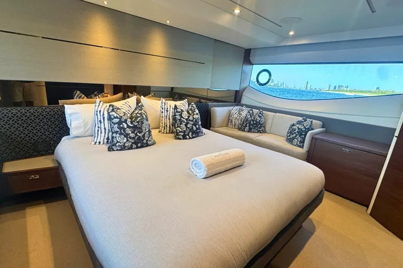 B III Yacht Photos Pics Luxurious bedroom interior of 2021 Princess S62 yacht with elegant decor and scenic window view.