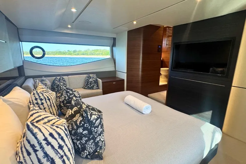 B III Yacht Photos Pics Luxurious 2021 Princess S62 yacht bedroom with elegant decor and scenic window view.