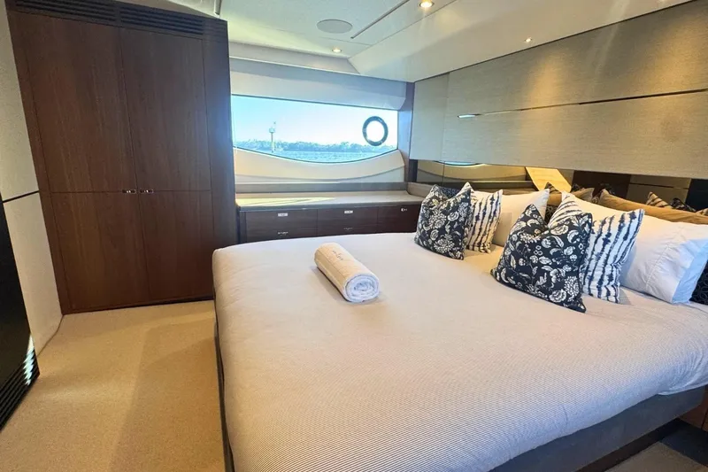 B III Yacht Photos Pics Luxurious bedroom interior of 2021 Princess S62 yacht with elegant decor and scenic window view.