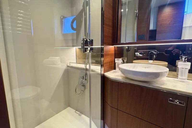 B III Yacht Photos Pics Luxurious bathroom in 2021 Princess S62 yacht with modern fixtures and elegant wood finishes.