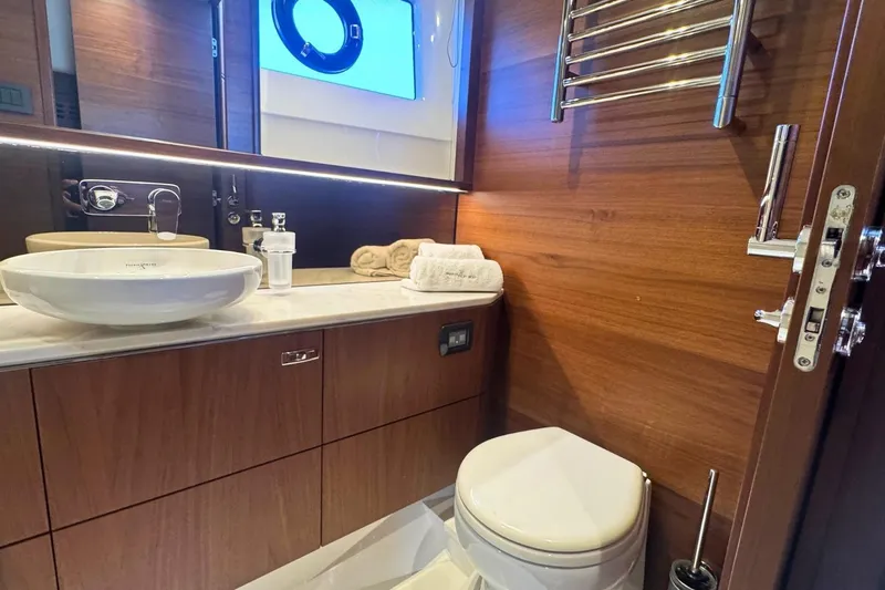 B III Yacht Photos Pics Luxurious bathroom in 2021 Princess S62 yacht with modern fixtures and wooden accents.