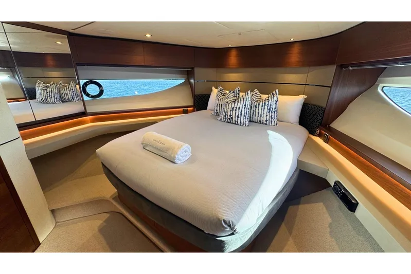 B III Yacht Photos Pics Luxurious bedroom interior of 2021 Princess S62 yacht with elegant bedding and ocean view.