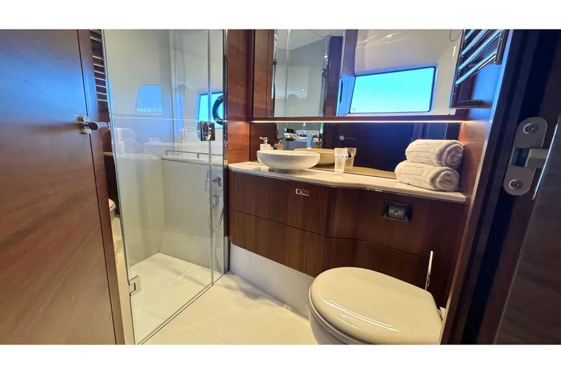 B III Yacht Photos Pics Luxurious bathroom in 2021 Princess S62 yacht with modern fixtures and elegant wood finishes.