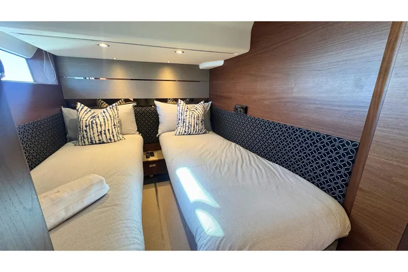 B III Yacht Photos Pics Luxurious twin cabin interior on 2021 Princess S62 yacht, featuring elegant bedding and wood paneling.