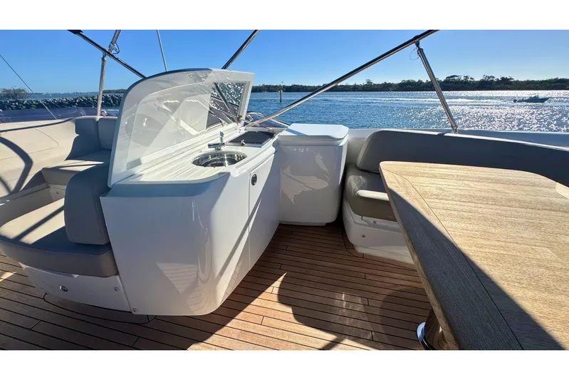 B III Yacht Photos Pics Luxurious 2021 Princess S62 yacht deck with seating, sink, and scenic water view.