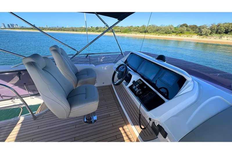 B III Yacht Photos Pics Flybridge helm of 2021 Princess S62 yacht with dual seats and navigation screens.