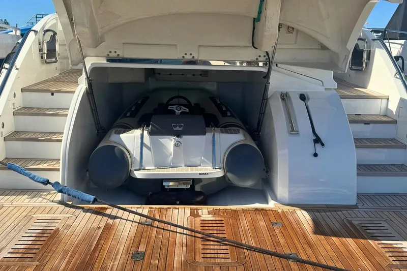 B III Yacht Photos Pics 2021 Princess S62 yacht with tender garage open, revealing stored inflatable boat.
