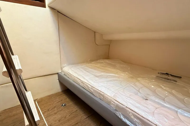 B III Yacht Photos Pics Cozy cabin interior of 2021 Princess S62 yacht with a neatly made bed.
