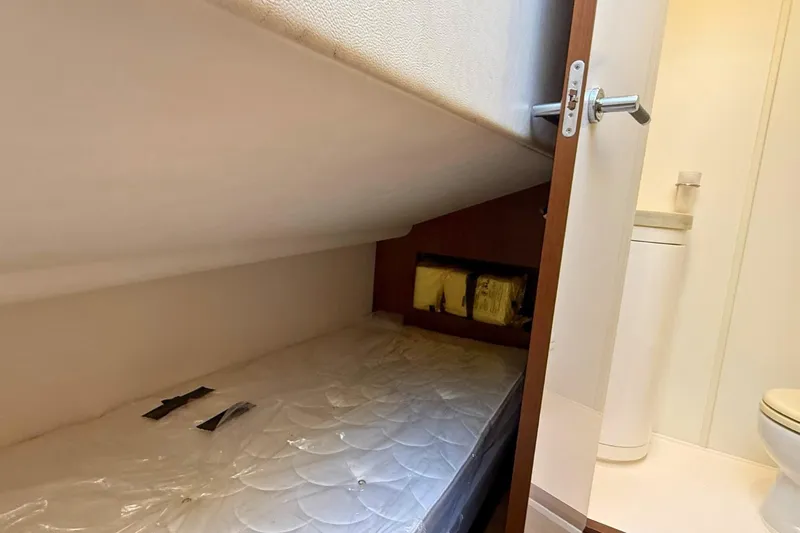 B III Yacht Photos Pics Compact cabin space in 2021 Princess S62 yacht with mattress and bathroom view.