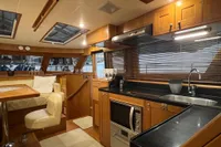 Luxurious 2007 Trader 42 HT yacht interior with modern kitchen and dining area.