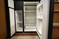 Open refrigerator and freezer in a 2007 Trader 42 HT yacht kitchen.