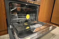 Open dishwasher in a 2007 Trader 42 HT yacht kitchen.