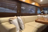 Luxurious interior of 2007 Trader 42 HT yacht with beige leather seating and wooden blinds.