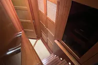 Interior of 2007 Trader 42 HT yacht with wooden cabinetry and stairs.
