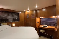 Luxurious cabin interior of 2007 Trader 42 HT yacht with wooden finish and cozy lighting.