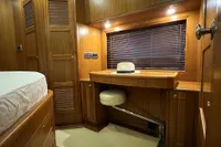 Luxurious wooden interior of 2007 Trader 42 HT yacht cabin with desk and hat.