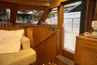 Interior of 2007 Trader 42 HT yacht, featuring wooden cabinetry and cozy seating.