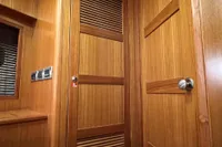 Wooden interior of 2007 Trader 42 HT yacht, featuring doors and control panel.