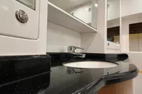 Luxurious bathroom sink with black countertop in 2007 Trader 42 HT yacht.