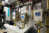 Engine room of 2007 Trader 42 HT yacht with fuel filters and piping system.