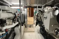 Engine room of a 2007 Trader 42 HT yacht, showcasing dual engines and metallic finishes.