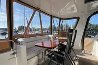 Luxurious 2007 Trader 42 HT yacht interior with elegant seating and marina view.