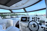Helm of 2007 Trader 42 HT yacht with modern navigation equipment and panoramic windows.