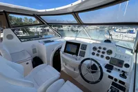 Helm of 2007 Trader 42 HT yacht with modern navigation equipment and white seating.
