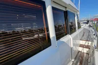 Side view of 2007 Trader 42 HT yacht with wooden deck and reflective windows.