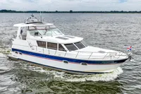 2007 Trader 42 HT yacht cruising on open water, displaying sleek design and elegance.