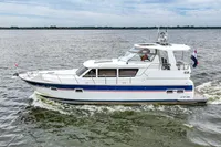 2007 Trader 42 HT yacht cruising on open water, side view.