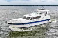 2007 Trader 42 HT yacht cruising on open water, showcasing sleek design and luxury features.