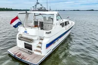 2007 Trader 42 HT yacht on water, rear view with flag, spacious deck.