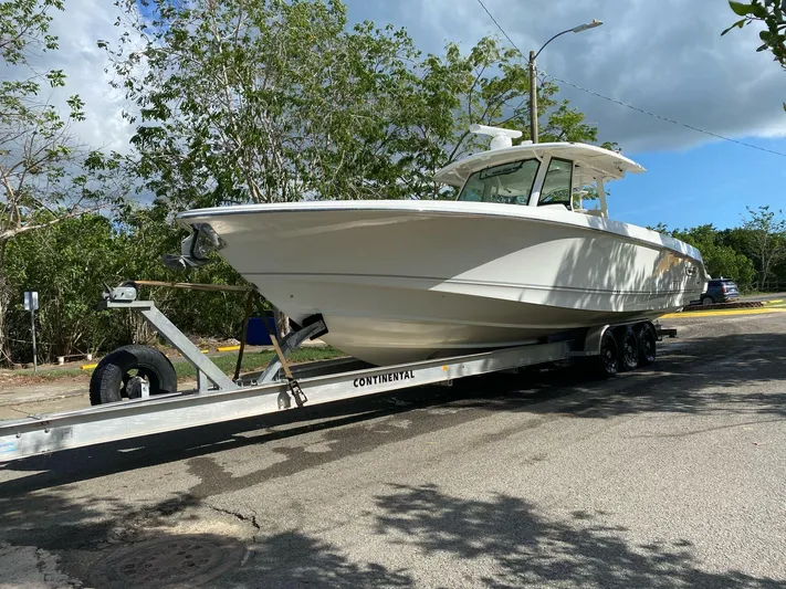  Yacht Photos Pics 2017 Boston Whaler 380 Outrage on trailer, parked outdoors under cloudy sky.